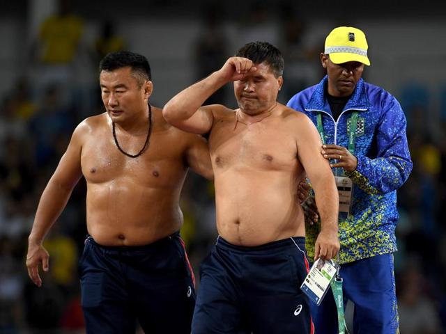 Two Mongolian coaches stripped their clothes off after wrestler Ganzorigiin Mandakhnaran lost the match.(Getty Images) Two Mongolian coaches stripped their clothes off after wrestler Ganzorigiin Mandakhnaran lost the match.(Getty Images)