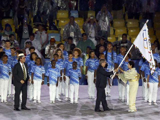 As a representative of the 2020 Olympics host city, Tokyo governor Yuriko Koike accepts the Olympic flag from International Olympic Committee (IOC) president Thomas Bach as Rio de Janeiro mayor Eduardo Paes looks on. (REUTERS)