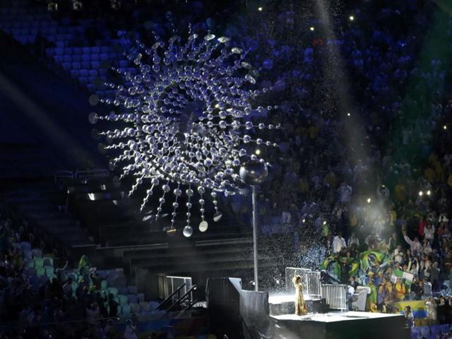 The Olympic flame is extinguished as Brazilian singer Mariene de Castro performs. (REUTERS)