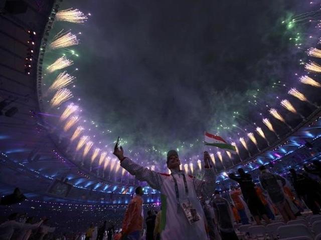 Participants celebrate and take pictures of fireworks during the Parade of Nations. (Reuters)