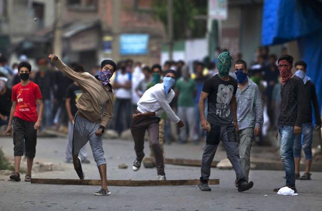 In this July 30, 2016, file photo, masked Kashmir protesters throw bricks and rocks at Indian policemen during a protest in Srinagar. (AP file photo)