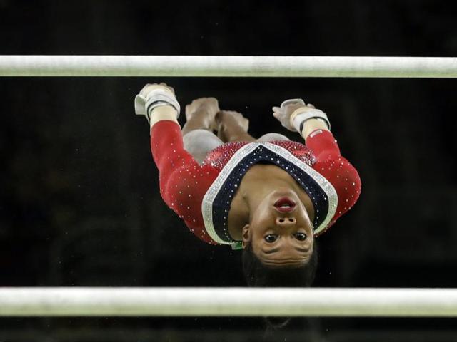 United States' Gabrielle Douglas performs on the uneven bars during the artistic gymnastics women's apparatus final at the 2016 Summer Olympics in Rio de Janeiro on August 14, 2016.  (Dmitri Lovetsky / AP Photo) 