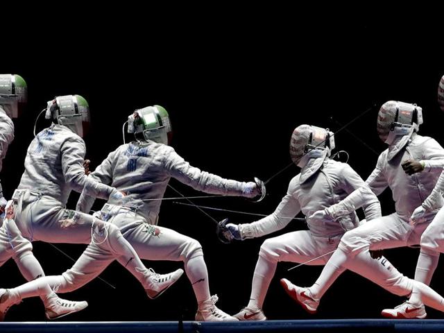 In a photo taken using multiple exposure, Iran's Mojtaba Abedini, left, and United State's Daryl Homer compete in a men's individual sabre semifinal at the 2016 Summer Olympics in Rio de Janeiro on August 10, 2016. (Charlie Riedel / AP Photo) 