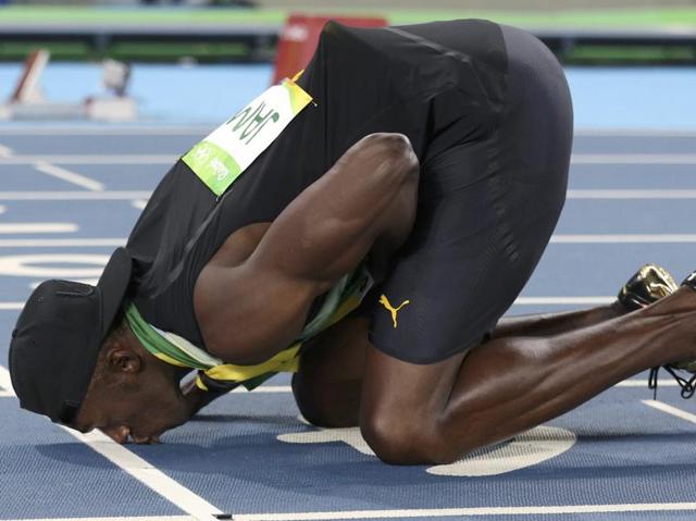 Usain Bolt kisses the track after his team won the gold. Argued to be the fastest man on the planet, the Jamaican sprinter signed off his Olympic gold rush with three medals this time. (Phil Noble/REUTERS) 