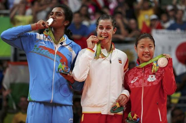 Gold medallist Carolina Marin of Spain, silver medallist P V Sindhu of India and bronze medallist Nozomi Okuhara of Japan pose together. (Reuters)