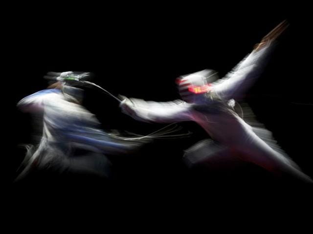 Andrea Baldini  of Italy competes with Gerek Meinhardt  of the US for the bronze medal in the fencing men's foil team match at the Carioca Arena 3 in Rio de Janeiro on August 12, 2016. (Carlos Barria / Reuters) 