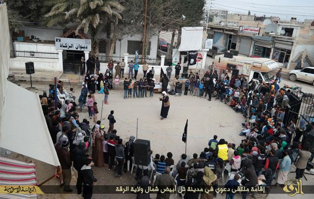 In this file photo released on Jan. 6, 2015, by a militant website, an Islamic State militant (centre) speaks to youths during a street preaching event at Tel Abyad town in Raqqa province, northeast Syria. (AP) In this file photo released on Jan. 6, 2015, by a militant website, an Islamic State militant (centre) speaks to youths during a street preaching event at Tel Abyad town in Raqqa province, northeast Syria. (AP)