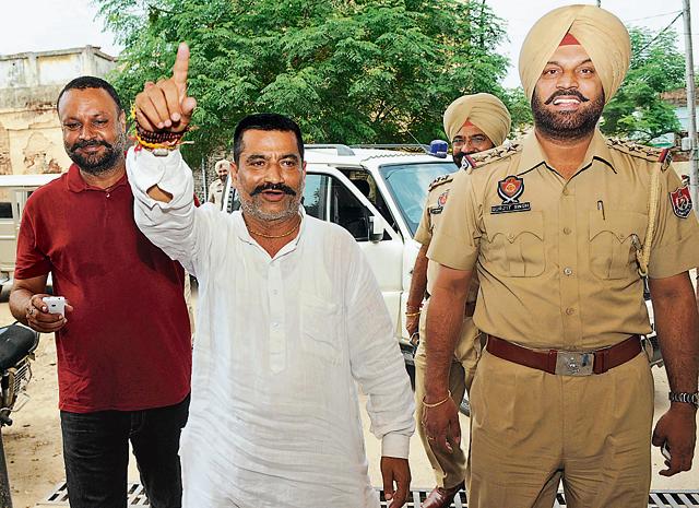 Punjab Gau Raksha Dal chief Satish Kumar (in white) coming out of a Rajpura court in Patiala on Sunday. (Bharat Bhushan/HT) Punjab Gau Raksha Dal chief Satish Kumar (in white) coming out of a Rajpura court in Patiala on Sunday. (Bharat Bhushan/HT)