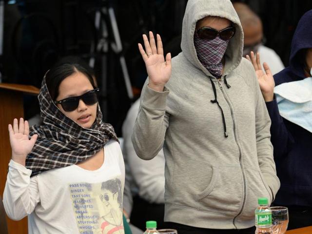 Harra Kazou (left), 26, and another witness take an oath at the start of a senate inquiry into a spate of extra judicial killings in Manila. (AFP Photo) Harra Kazou (left), 26, and another witness take an oath at the start of a senate inquiry into a spate of extra judicial killings in Manila. (AFP Photo)