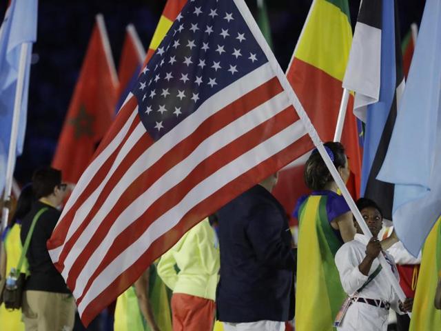 Gymnast Simone Biles, winner of five medals, carries the flag of the United States. (AP)