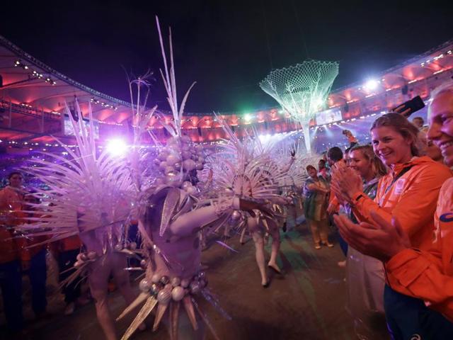 Athletes from the Netherlands, right, applaud as dancers march in. (AP)