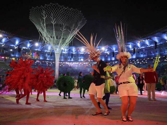 Dagmar Wozniak of the United States, right, dances with other athletes during the ceremony. (AP)