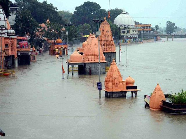 People walking through the flood water Ghazipur, Uttar Pradesh, on August 21, 2016.(Rajesh Kumar / HT Photo)