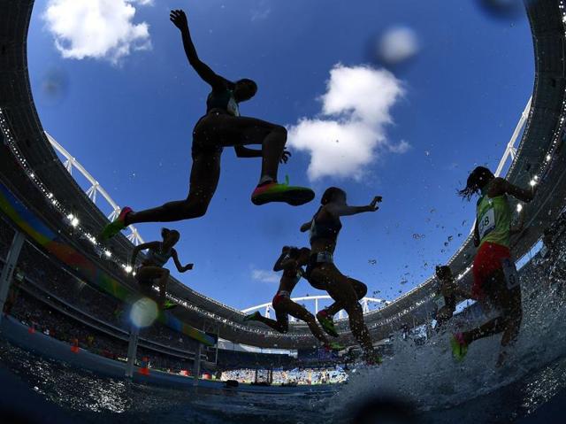 Athletes compete in the women's 3,000m steeplechase round 1 during the athletics event at the Olympic Stadium in Rio de Janeiro on August 13, 2016. (Franck Fife/ AFP Photo) 