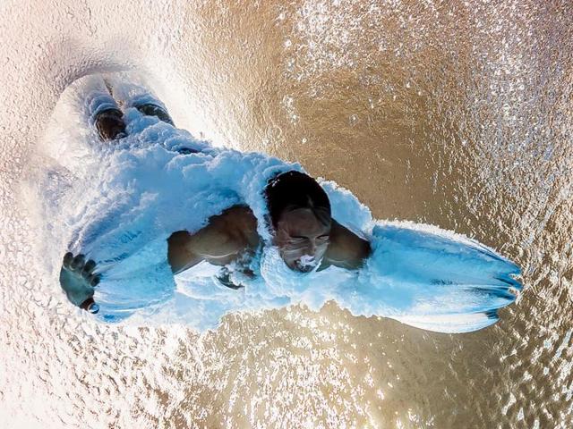 An underwater camera clicks Britain's Thomas Daley competing in the men's 10m platform semifinal during the diving event at the Rio 2016 Olympic Games at the Maria Lenk Aquatics Stadium in Rio de Janeiro on August 20, 2016.  (François-Xavier Marit / AFP Photo) 