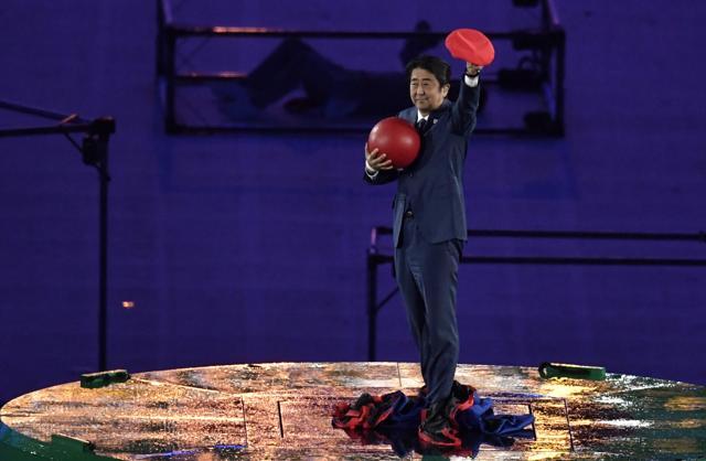 Abe takes off his Mario outfit and acknowledges the crowd in Maracana Stadium. (AFP)