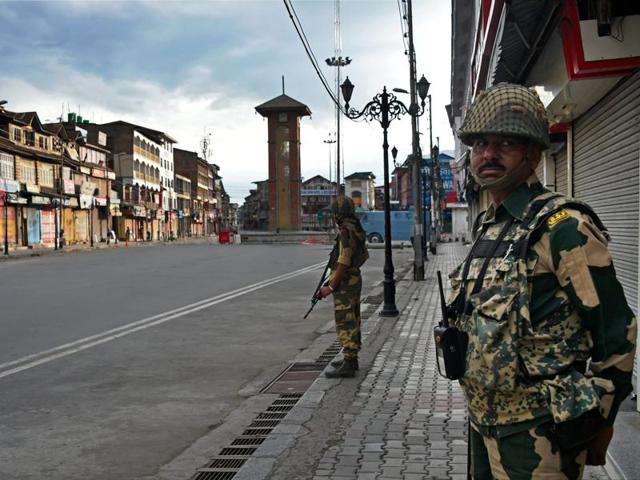 BSF jawans stand guard during curfew in Srinagar on Monday. A video purportedly showing two Kashmir police officers resigning in public has gone viral. (PTI Photo) BSF jawans stand guard during curfew in Srinagar on Monday. A video purportedly showing two Kashmir police officers resigning in public has gone viral. (PTI Photo)