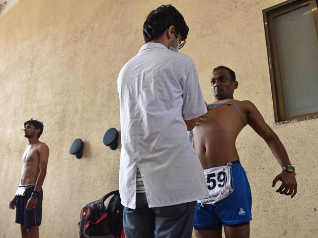 Men stand in for chest measurement and weighing during Fire Brigade recruitment drive at Borivali. Minimum size of 81 centimeter and 86 after inflation of chest is required to get selected. Candidates go through various physical tests during recruitment and get selected for training after the result of recruitment drive. After training for 6 months, 774 posts of firemen will get fulfilled through merit. (Pratham Gokhale)