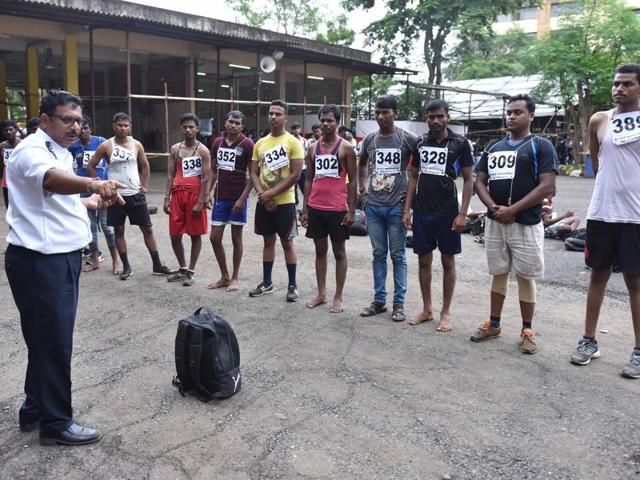 Men get instructions from a fire officer during Fire Brigade recruitment drive at Borivali. Candidates go through various physical tests during recruitment and get selected for training after the result of recruitment drive. After training for 6 months, 774 posts of firemen will get fulfilled through merit. (Pratham Gokhale)
