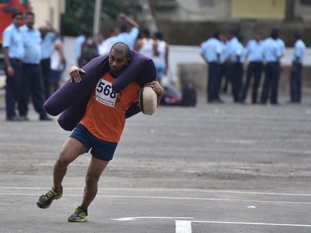 A man runs as he carries dummy of a person of 60 kg during rescue exercise at Fire Brigade recruitment drive at Borivali. Candidates have run for 60 meters with the dummy and the person who completes the task in 20 seconds, gets full marks. The candidates go through various physical tests during recruitment and get selected for training after the result of recruitment drive. After training for 6 months, 774 posts of firemen will get fulfilled through merit. (Pratham Gokhale)