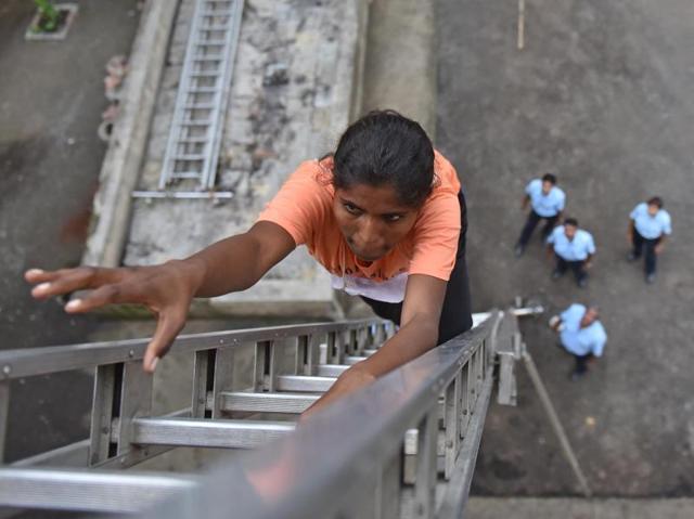 A girl climbs on angus ladder during Fire Brigade recruitment drive at Borivali. Candidates who complete this task in 20 seconds, get full marks and who take more than 40 seconds to complete the task get 0 marks. The candidates go through various physical tests during recruitment and get selected for training after the result of recruitment drive. After training for 6 months, 774 posts of firemen will get fulfilled through merit. (Pratham Gokhale)