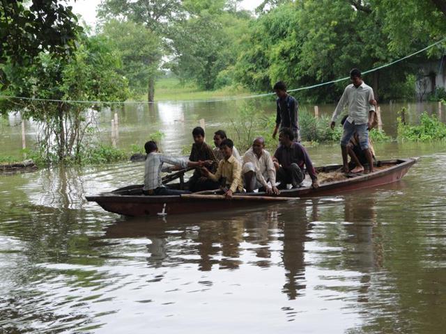 People of flood-affected Pipalkhedi village travel in a boat. There is a flood-like situation in the area after three sluice gates of the Halali dam, 55 km from Bhopal, were opened on Monday. (Praveen Bajpai/ HT photo) People of flood-affected Pipalkhedi village travel in a boat. There is a flood-like situation in the area after three sluice gates of the Halali dam, 55 km from Bhopal, were opened on Monday. (Praveen Bajpai/ HT photo)