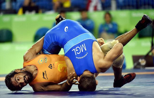 Yogeshwar Dutt fights with Mongolian wrestler Mandakhnaran Ganzorig during the Men's 65kg Freestyle wrestling match at Summer Olympics 2016 in Rio de Janeiro in Brazil. (PTI Photo)