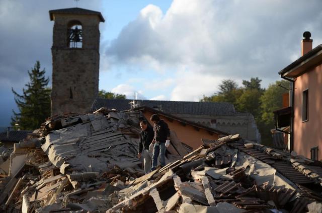 Two men walk on a damaged home after a strong earthquake hit Amatrice. The first quake struck shortly after 3.30 am (0130 GMT), according to the United States Geological Survey. (AFP) Two men walk on a damaged home after a strong earthquake hit Amatrice. The first quake struck shortly after 3.30 am (0130 GMT), according to the United States Geological Survey. (AFP)