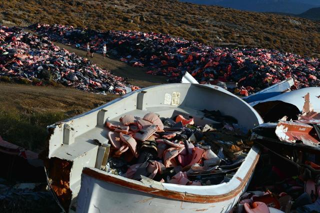 Tourists visit the dump above the village of Molyvos with thousands of life jackets next to boats collected from the shores. (AFP File Photo) Tourists visit the dump above the village of Molyvos with thousands of life jackets next to boats collected from the shores. (AFP File Photo)
