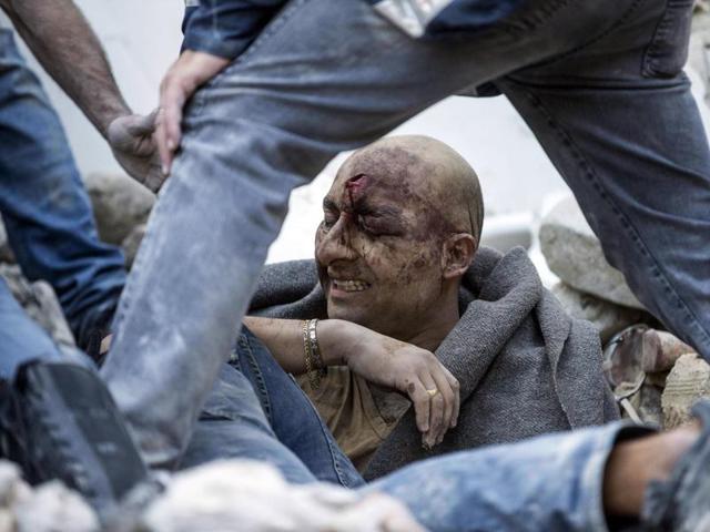 A man is pulled out of the rubble following an earthquake in Amatrice. (AP Photo)
