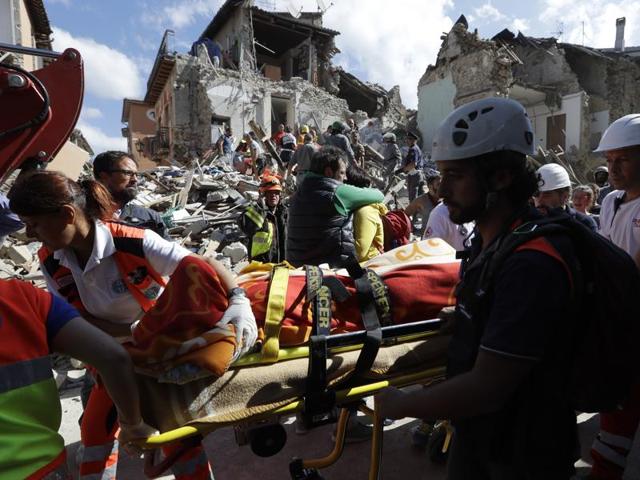 A victim is pulled out of the rubble following an earthquake in Amatrice. (AP Photo)