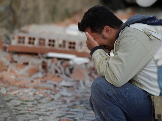 A man reacts after a strong earthquake hit Amatrice. (AFP Photo)