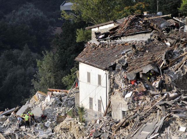 Rescuers search for survivors amidst collapsed buildings following an earthquake, in Pescara del Tronto, Italy.(AP)