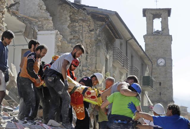 A victim is carried on a stretcher from a collapsed building. (AP) A victim is carried on a stretcher from a collapsed building. (AP)