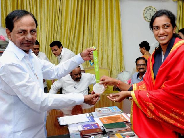 Sindhu poses for a photograph with her medal with Telangana Chief Minister K Chandrasekhar Rao. (PTI) Sindhu poses for a photograph with her medal with Telangana Chief Minister K Chandrasekhar Rao. (PTI)
