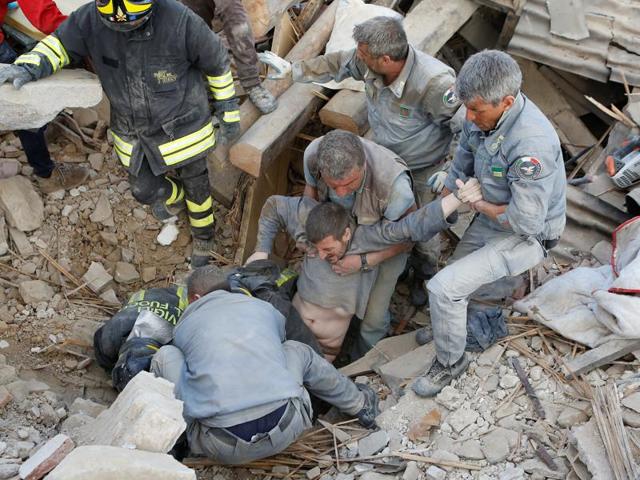 A man is rescued alive from the ruins following an earthquake in Amatrice. (REUTERS)