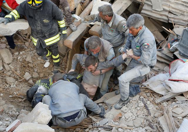 A man is rescued alive from the ruins. (REUTERS) A man is rescued alive from the ruins. (REUTERS)