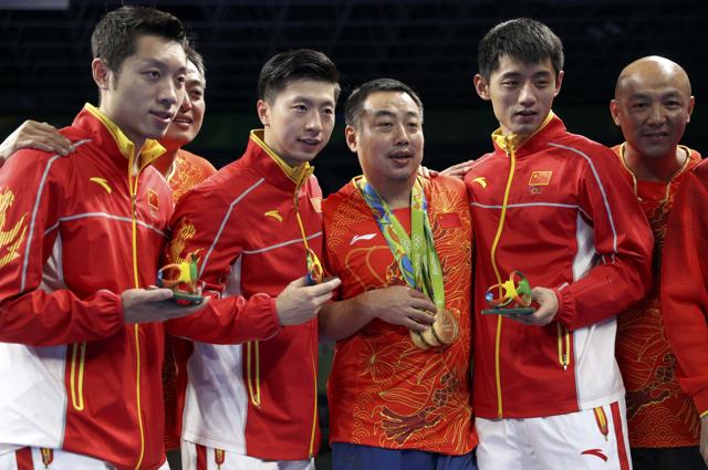 China’s team members pose on the podium after winning gold in the men’s team event at the Rio Olympics.(REUTERS) China’s team members pose on the podium after winning gold in the men’s team event at the Rio Olympics.(REUTERS)