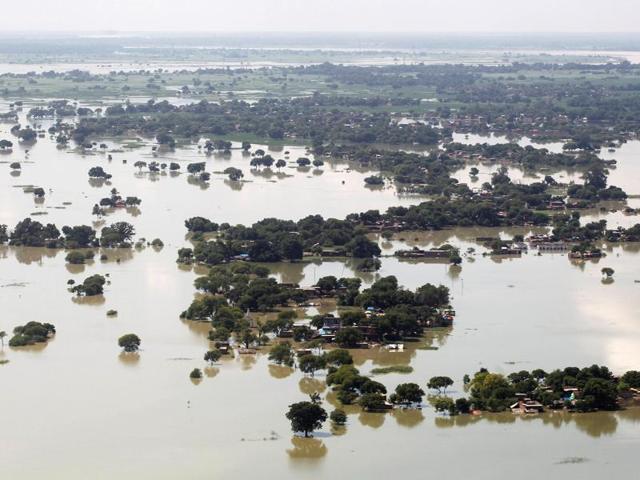 Over a 100 people have been killed and lakhs are homeless as floods continue to ravage Uttar Pradesh and Bihar. This picture shows an aerial view of a flooded village on the outskirts of Allahabad.  (REUTERS/Jitendra Prakash) 