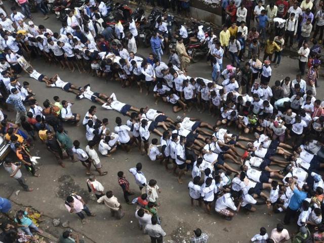 The Kokannagar Govinda Pathak was the first to form a sleeping pyramid on the road around 10 am at Dadar. (KUNAL PATIL) The Kokannagar Govinda Pathak was the first to form a sleeping pyramid on the road around 10 am at Dadar. (KUNAL PATIL)