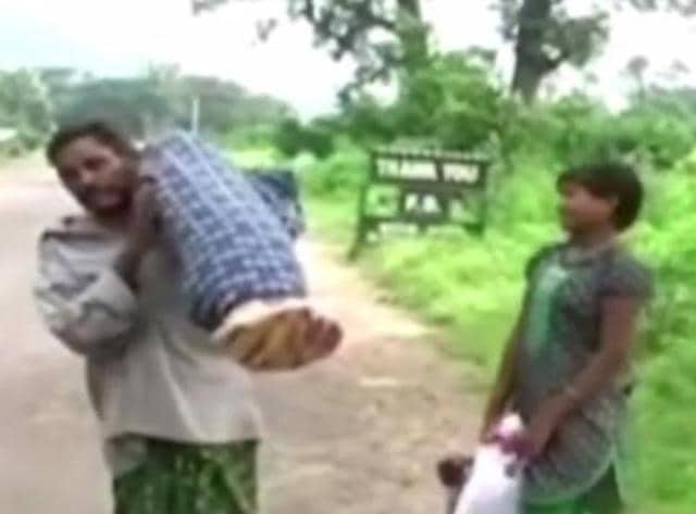 Dana Manjhi carried his wife’s body on shoulders as he was denied a mortuary van or ambulance by hospital authorities. (Photo credit: OTV Video Grab) Dana Manjhi carried his wife’s body on shoulders as he was denied a mortuary van or ambulance by hospital authorities. (Photo credit: OTV Video Grab)