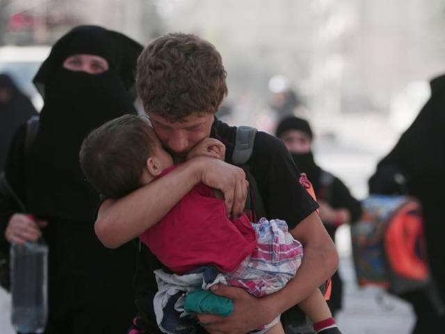 A civilian carries a child as he walks with others after they were evacuated by the Syria Democratic Forces (SDF) fighters from an Islamic State-controlled neighbourhood of Manbij, in Aleppo, Syria. (Reuters File Photo) A civilian carries a child as he walks with others after they were evacuated by the Syria Democratic Forces (SDF) fighters from an Islamic State-controlled neighbourhood of Manbij, in Aleppo, Syria. (Reuters File Photo)