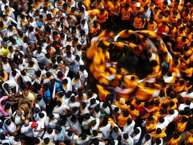 Devotees dance after breaking the dahi handi containing curd in Mumbai. (REUTERS) Devotees dance after breaking the dahi handi containing curd in Mumbai. (REUTERS)