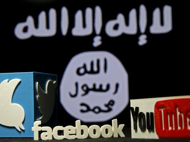 3D plastic representations of the Twitter, Facebook and Youtube logos are seen in front of a displayed Islamic State flag in this photo illustration. (REUTERS) 3D plastic representations of the Twitter, Facebook and Youtube logos are seen in front of a displayed Islamic State flag in this photo illustration. (REUTERS)