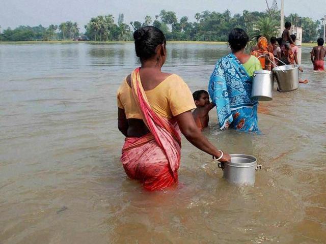 Locals walk to collect potable water from a hand pump at a flooded area in Udaynarayanpur in Howrah district of West Bengal. (PTI) Locals walk to collect potable water from a hand pump at a flooded area in Udaynarayanpur in Howrah district of West Bengal. (PTI)
