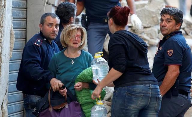 A woman cries after been rescued from her home following a quake in Amatrice. (Reuters Photo)