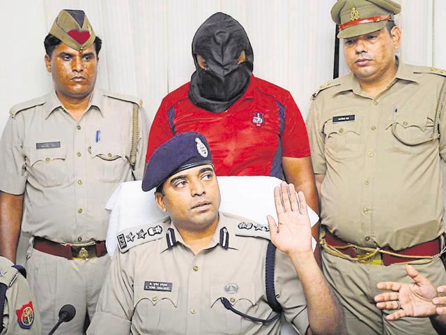 The 35-year-old (face covered) is the seventh suspect to be arrested in the case. (Sakib Ali/HT Photo) The 35-year-old (face covered) is the seventh suspect to be arrested in the case. (Sakib Ali/HT Photo)