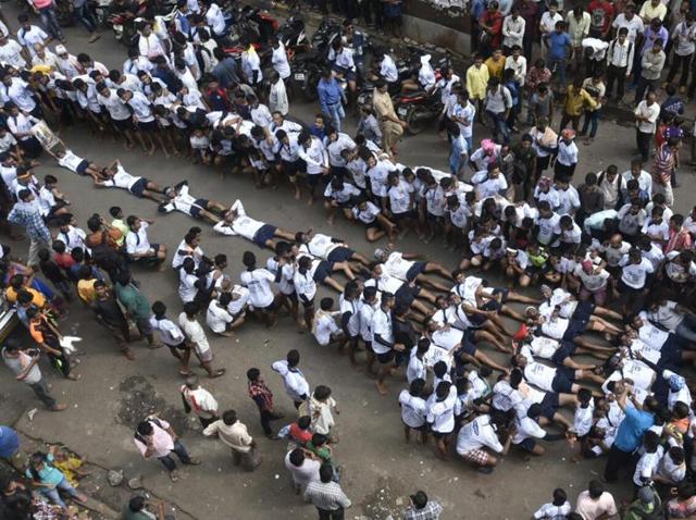 Govindas of the Kokan Nagar Govinda Pathak lie down, forming a 9-tier pyramid in protest against the Supreme Court order to restrict the height of pyramids to 20feet, at Dadar on Thursday. (Kunal Patil/ht) Govindas of the Kokan Nagar Govinda Pathak lie down, forming a 9-tier pyramid in protest against the Supreme Court order to restrict the height of pyramids to 20feet, at Dadar on Thursday. (Kunal Patil/ht)