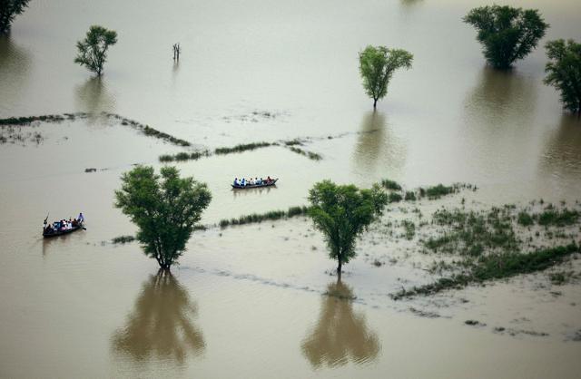 Villagers use boats to cross a flooded area on the outskirts of Allahabad. (AFP) Villagers use boats to cross a flooded area on the outskirts of Allahabad. (AFP)