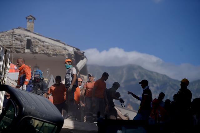 Volunteers work to move rubble and debris during search and rescue operations in Amatrice. (AFP) Volunteers work to move rubble and debris during search and rescue operations in Amatrice. (AFP)